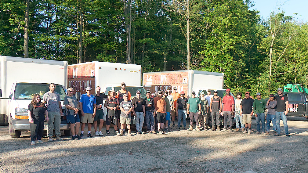 Fix My Brick team and crew members with company trucks - professional masonry contractors